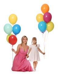 Photo of Happy mother in dress and her little daughter with bunches of colorful balloons holding hands on white background
