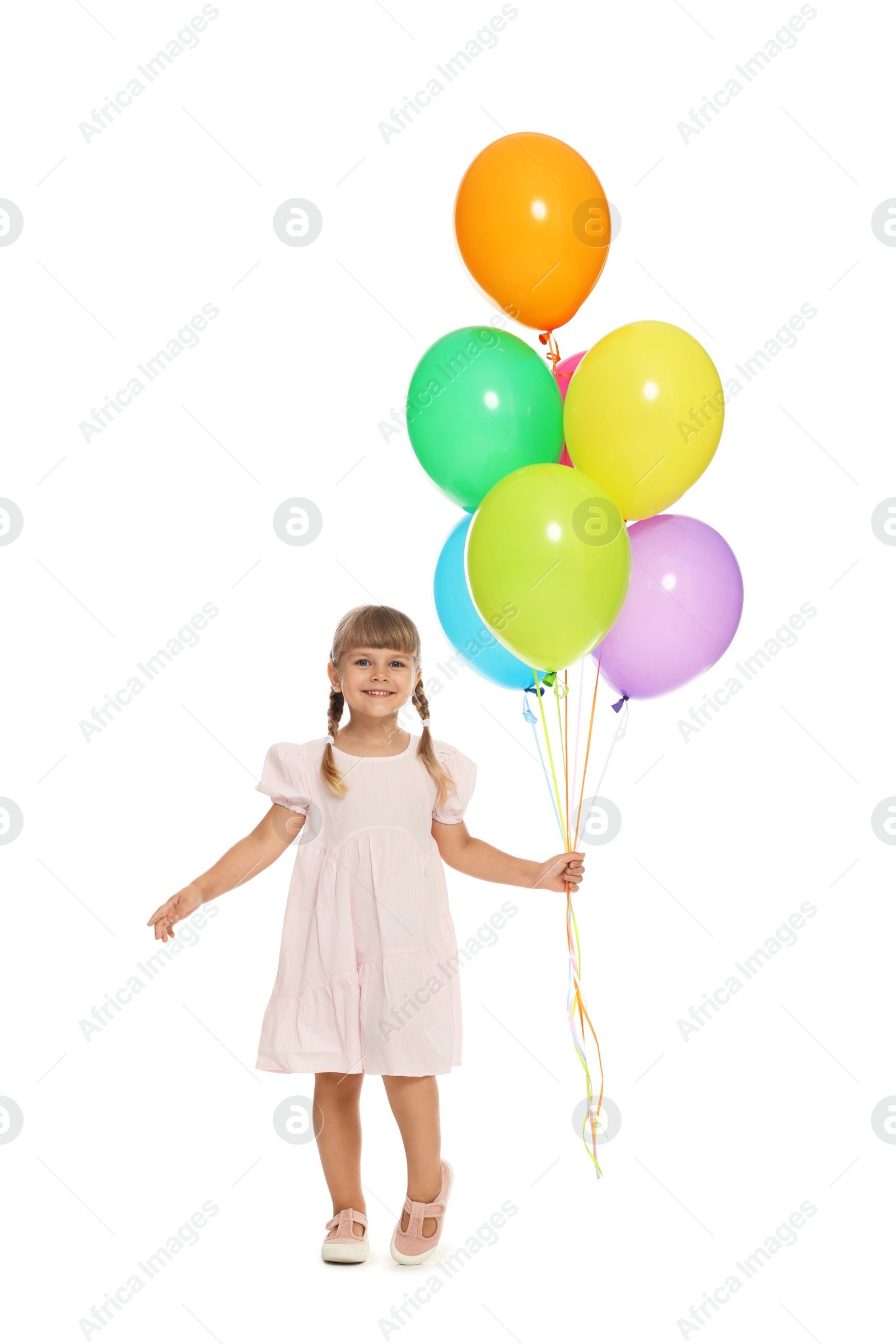Photo of Smiling little girl in dress with bunch of colorful balloons on white background