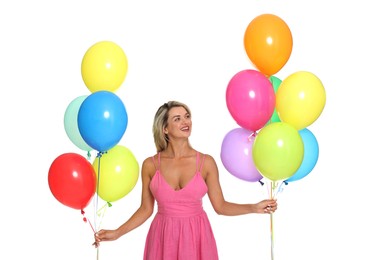 Photo of Smiling woman in dress with bunches of colorful balloons on white background