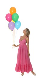 Photo of Smiling woman in dress with bunch of colorful balloons on white background