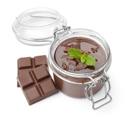 Photo of Delicious panna cotta in glass jar, pieces of chocolate and mint isolated on white