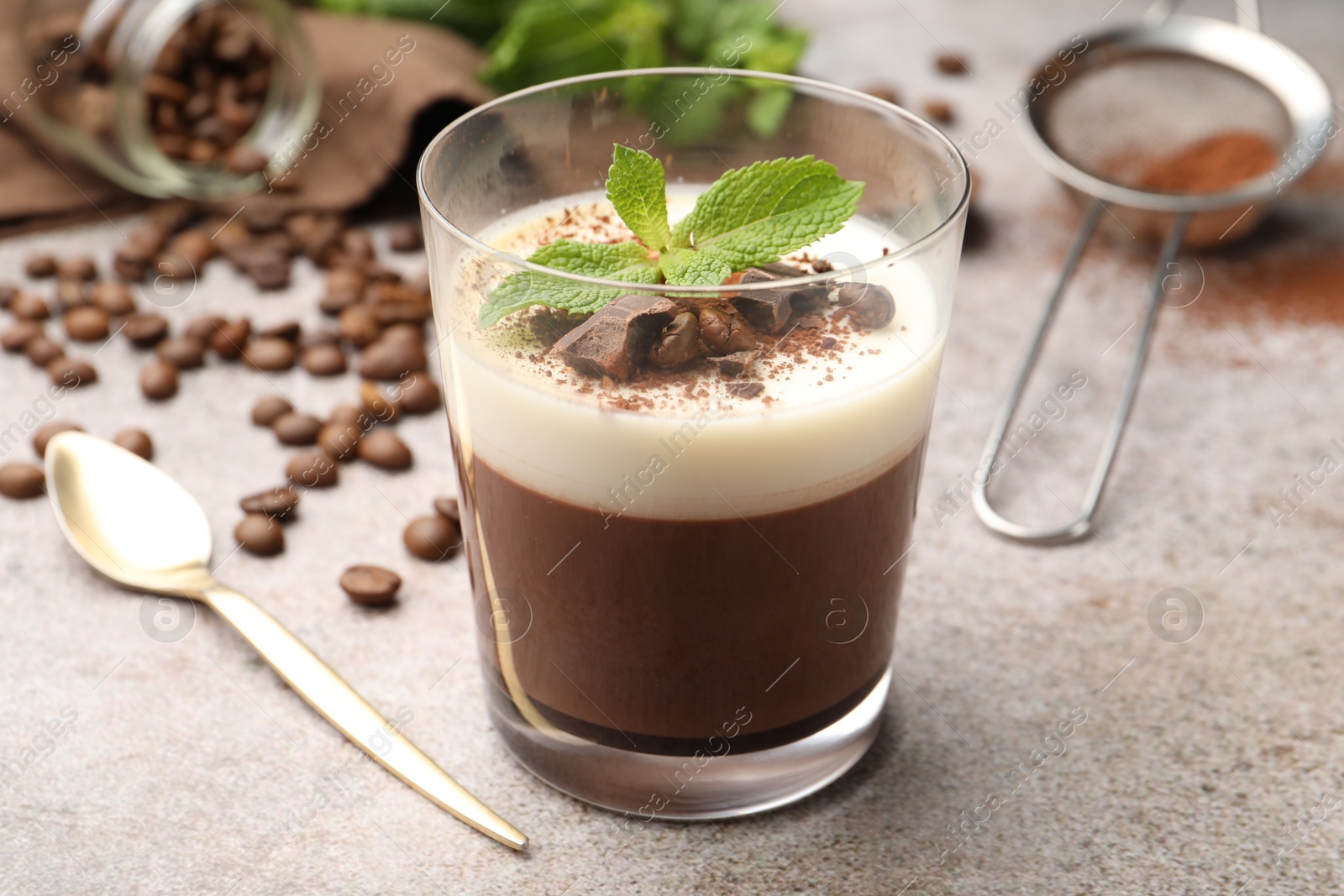 Delicious coffee panna cotta, beans and mint on grey table, closeup Photo of Delicious coffee panna cotta, beans and mint on grey table, closeup