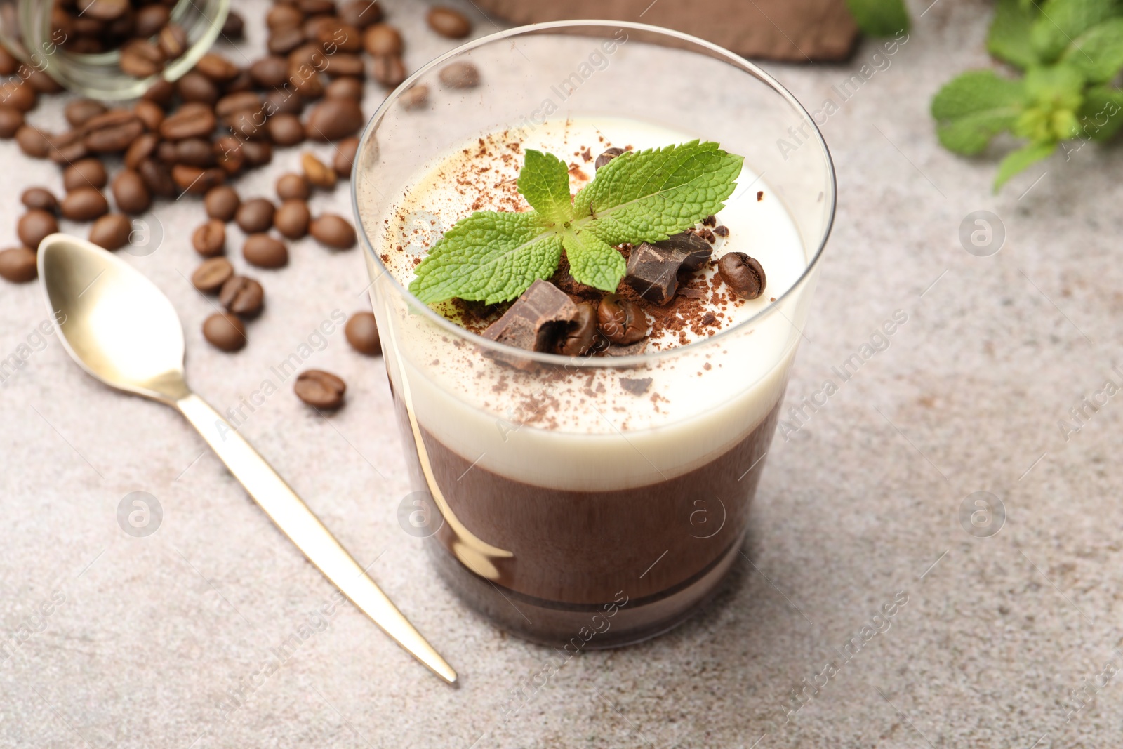 Delicious coffee panna cotta, beans and mint on grey table, closeup Photo of Delicious coffee panna cotta, beans and mint on grey table, closeup