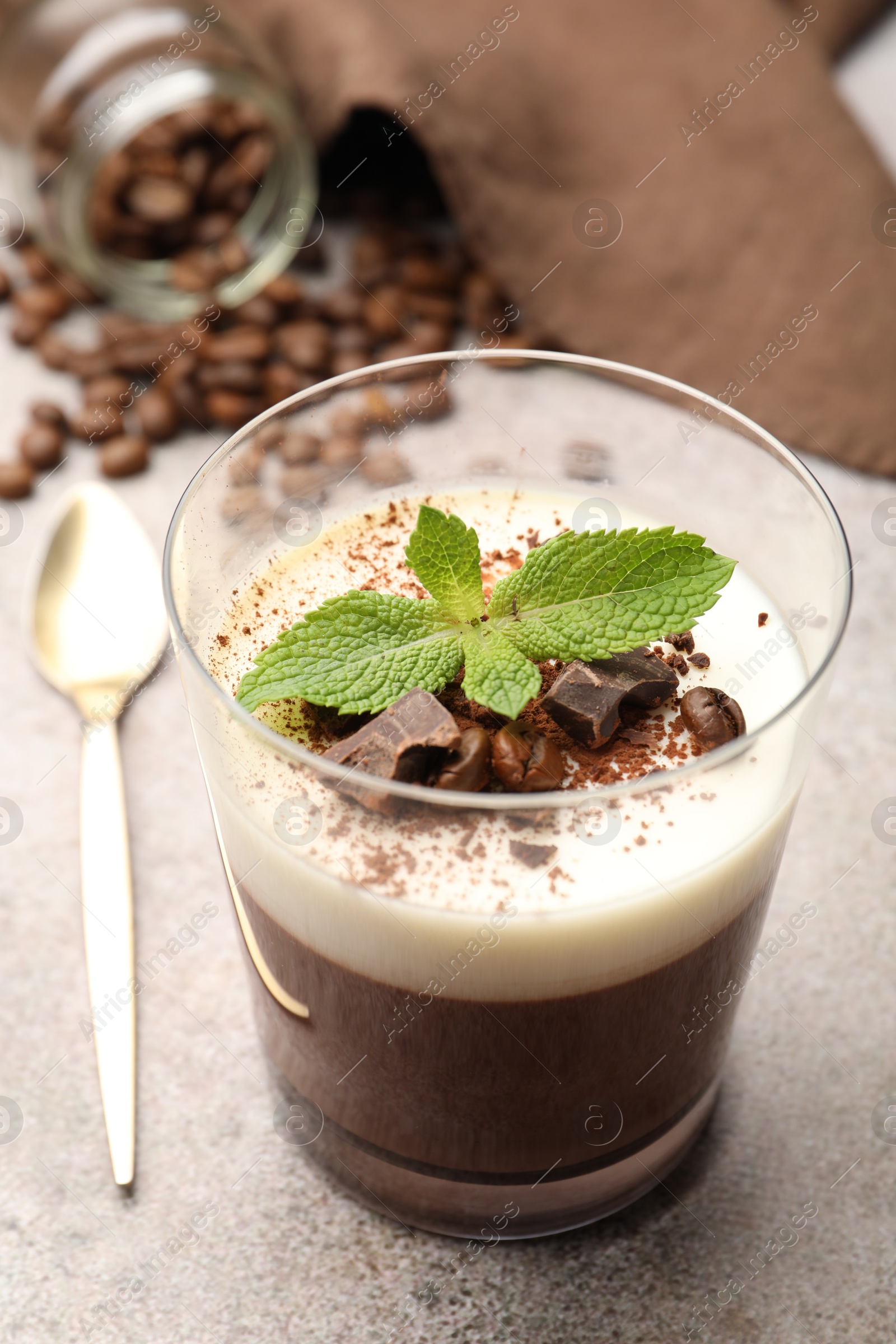 Delicious coffee panna cotta, beans and mint on grey table, closeup Photo of Delicious coffee panna cotta, beans and mint on grey table, closeup