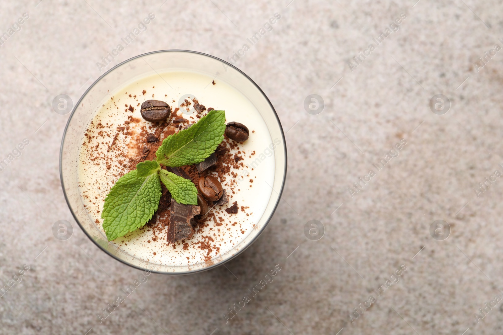 Delicious coffee panna cotta with beans and mint on grey table, top view. Space for text Photo of Delicious coffee panna cotta with beans and mint on grey table, top view. Space for text