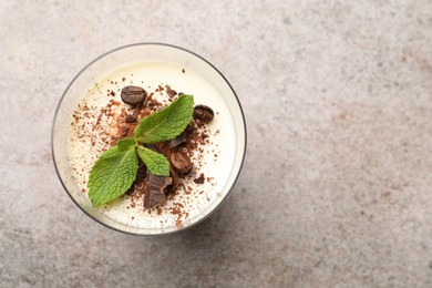 Photo of Delicious coffee panna cotta with beans and mint on grey table, top view. Space for text