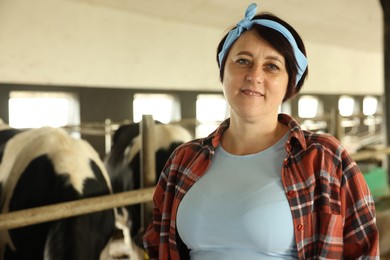 Photo of Portrait of farmer inside cowshed in dairy farm