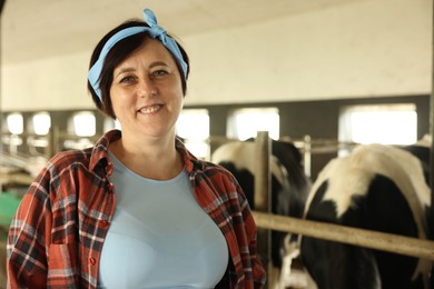 Photo of Portrait of farmer inside cowshed in dairy farm
