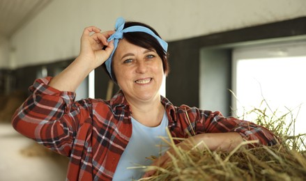 Photo of Portrait of farmer with hay in dairy farm