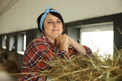 Photo of Portrait of farmer with hay in dairy farm