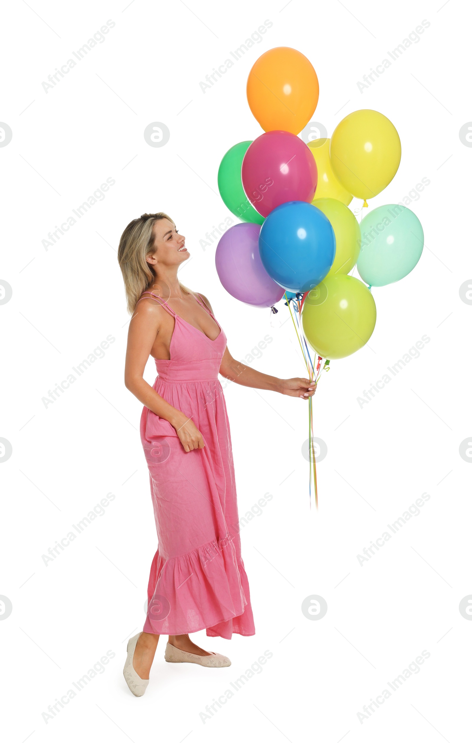 Photo of Smiling woman in dress with bunch of colorful balloons on white background