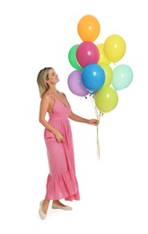 Photo of Smiling woman in dress with bunch of colorful balloons on white background