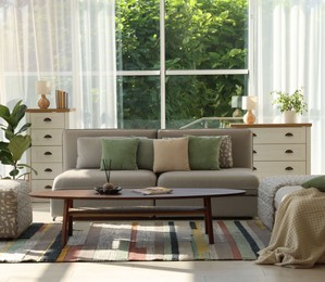 Photo of Stylish sofa and other furniture in living room. Interior design