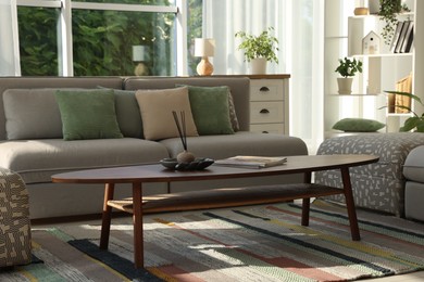 Photo of Stylish sofa and other furniture in living room. Interior design