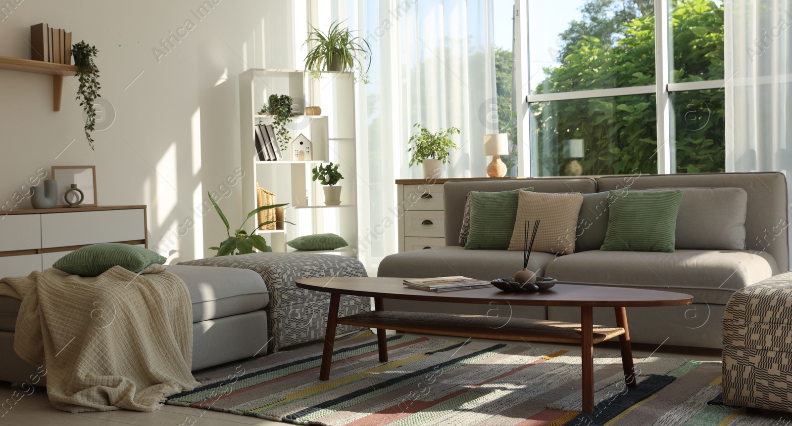 Photo of Stylish sofa and other furniture in living room. Interior design
