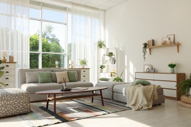 Photo of Stylish sofa and other furniture in living room. Interior design
