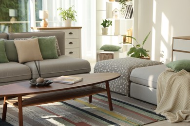 Photo of Stylish sofa and other furniture in living room. Interior design