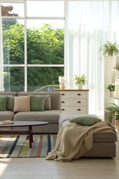 Photo of Stylish sofa and other furniture in living room. Interior design