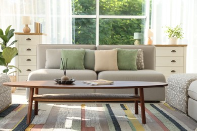 Photo of Stylish sofa and other furniture in living room. Interior design