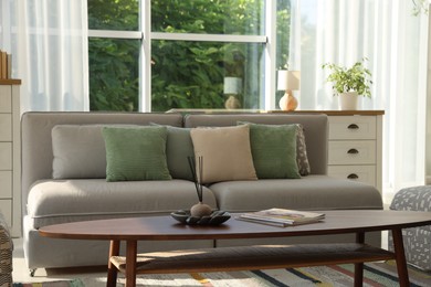 Photo of Stylish sofa and other furniture in living room. Interior design