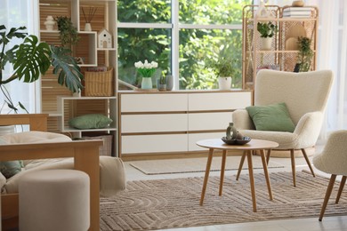 Photo of Stylish sofa and other furniture in living room. Interior design