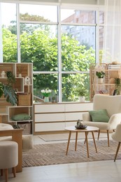 Photo of Comfortable armchairs and other furniture in living room. Interior design
