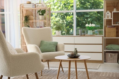 Photo of Comfortable armchairs and other furniture in living room. Interior design
