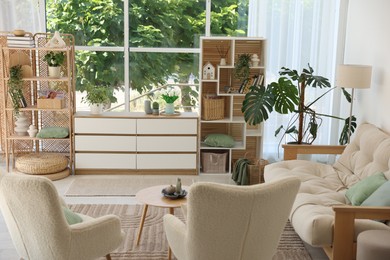 Photo of Stylish sofa and other furniture in living room. Interior design
