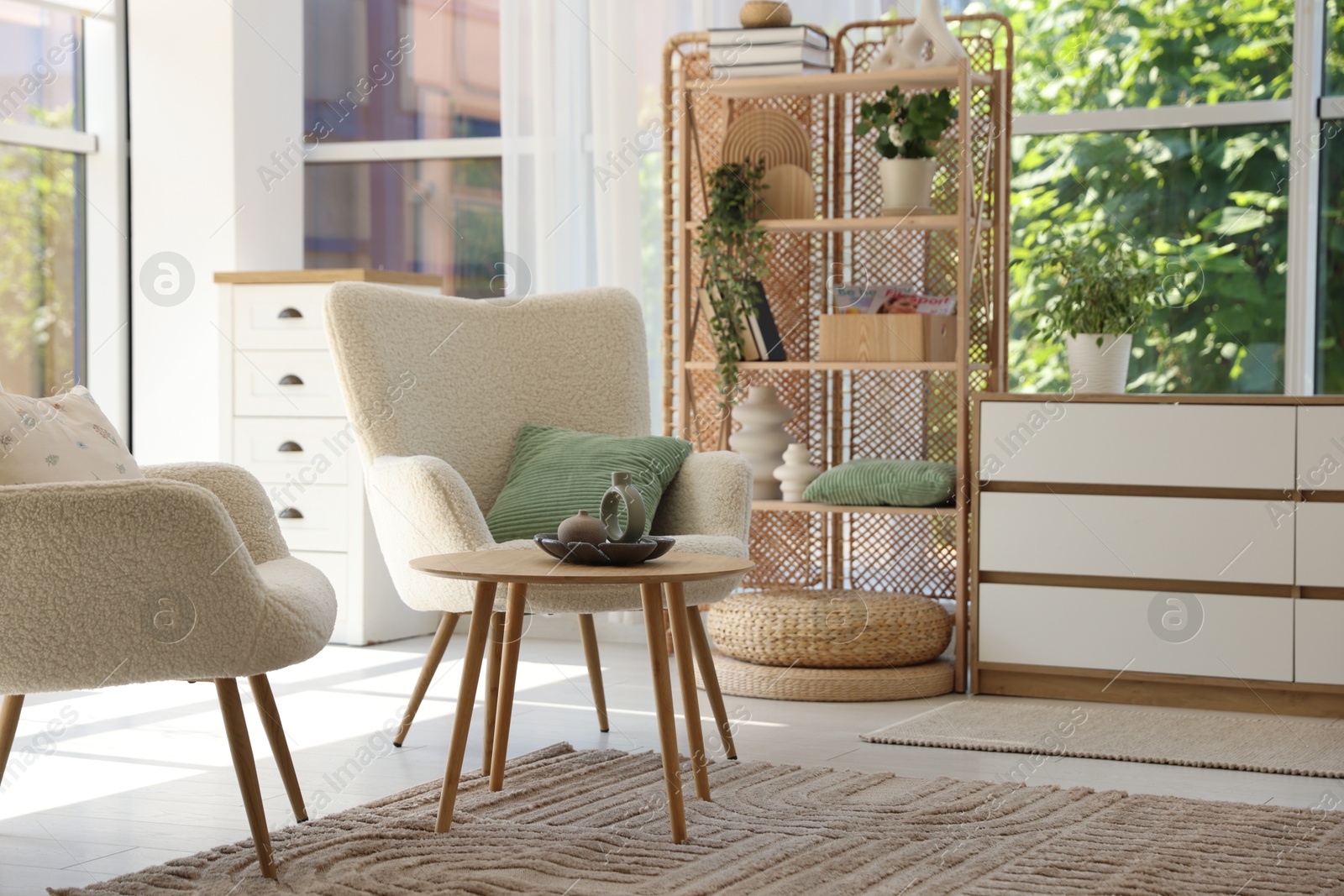 Photo of Comfortable armchairs and other furniture in living room. Interior design