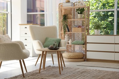 Photo of Comfortable armchairs and other furniture in living room. Interior design
