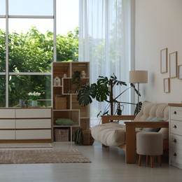 Photo of Stylish sofa and other furniture in living room. Interior design