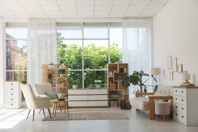 Photo of Stylish sofa and other furniture in living room. Interior design