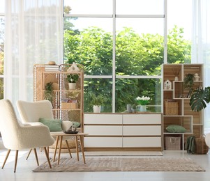 Photo of Comfortable armchairs and other furniture in living room. Interior design