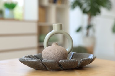 Photo of Beautiful vases on wooden table in living room, closeup