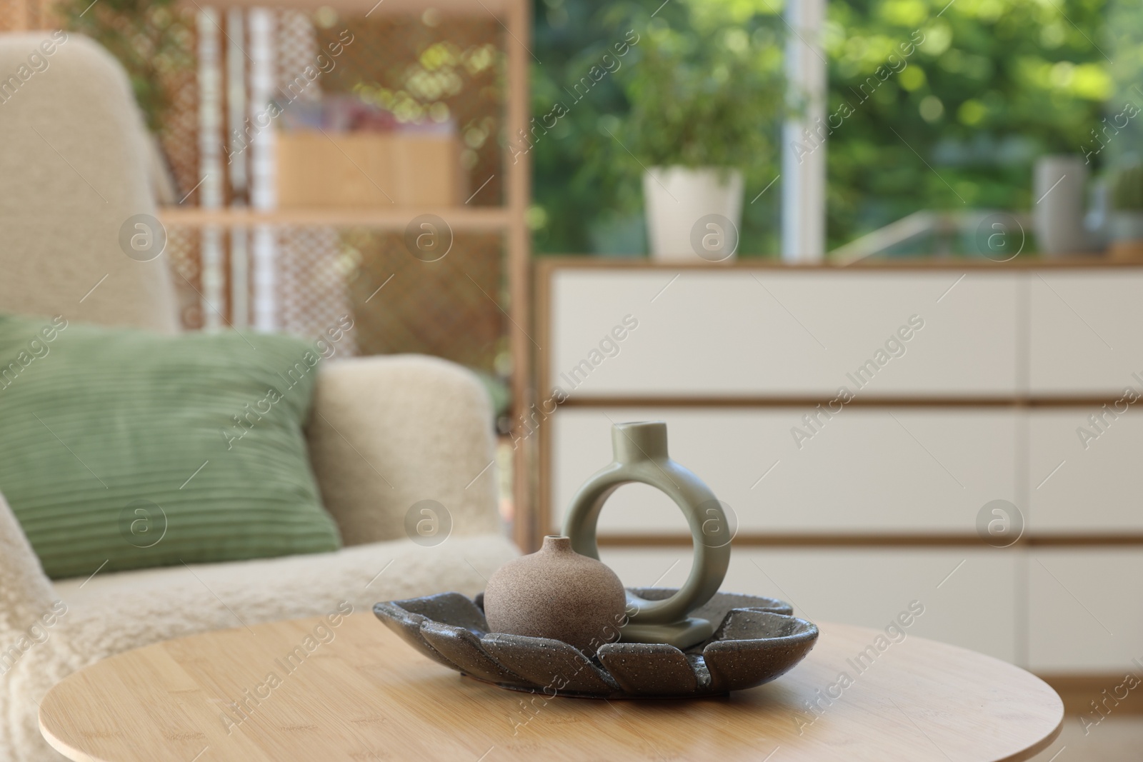 Photo of Beautiful vases on wooden table in living room, closeup