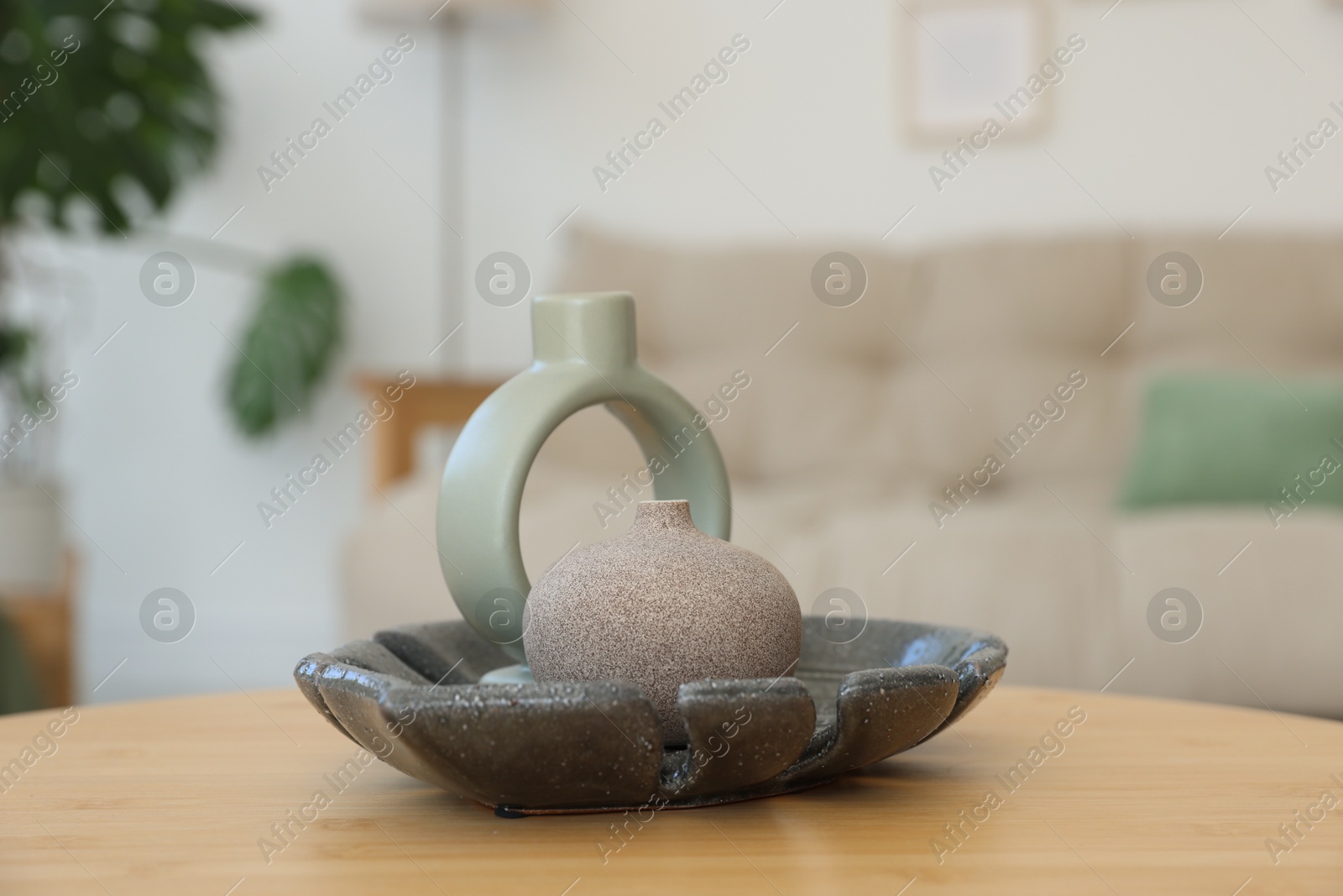 Photo of Beautiful vases on wooden table in living room, closeup