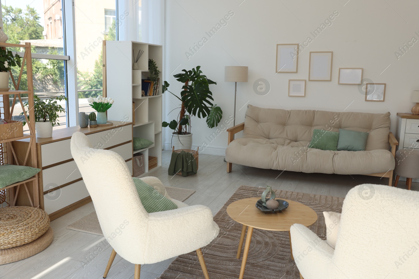 Photo of Stylish sofa and other furniture in living room. Interior design