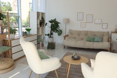 Photo of Stylish sofa and other furniture in living room. Interior design