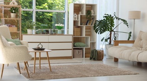 Photo of Stylish sofa and other furniture in living room. Interior design