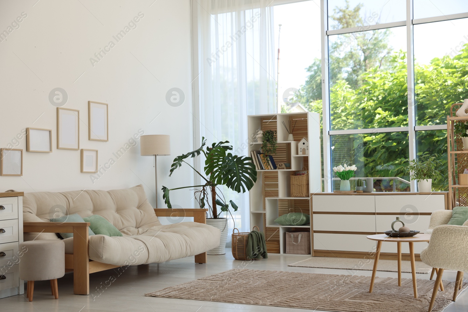 Photo of Stylish sofa and other furniture in living room. Interior design
