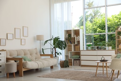 Photo of Stylish sofa and other furniture in living room. Interior design