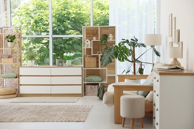Photo of Stylish sofa and other furniture in living room. Interior design