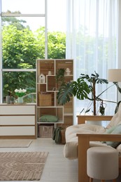 Photo of Stylish sofa and other furniture in living room. Interior design