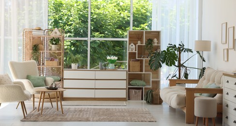 Photo of Stylish sofa and other furniture in living room. Interior design