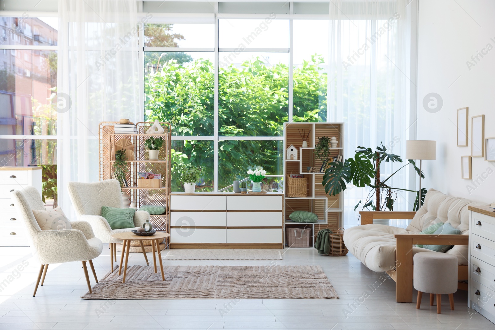 Photo of Stylish sofa and other furniture in living room. Interior design