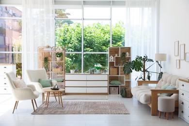 Photo of Stylish sofa and other furniture in living room. Interior design