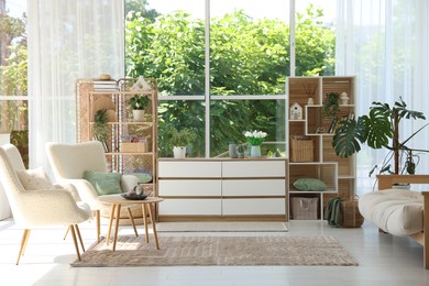 Photo of Stylish sofa and other furniture in living room. Interior design