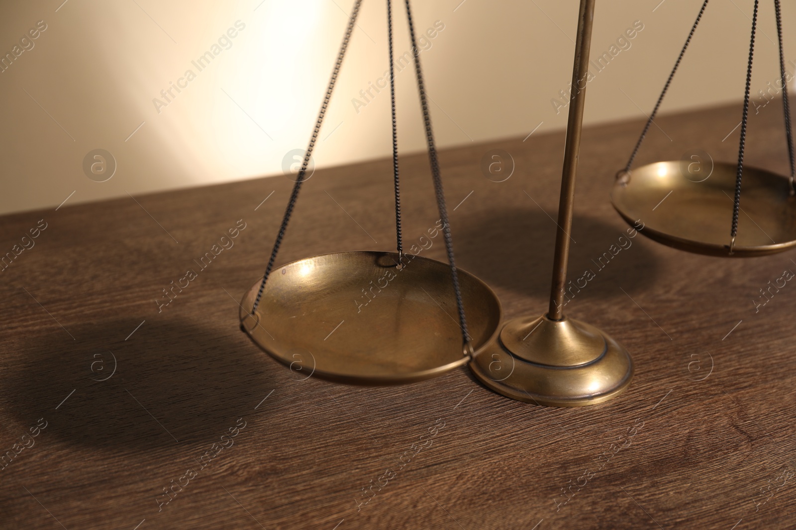Scales of justice on wooden table, closeup Photo of Scales of justice on wooden table, closeup