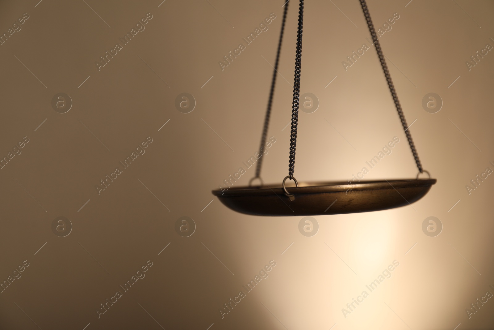 Photo of Scales of justice on beige background, closeup. Space for text