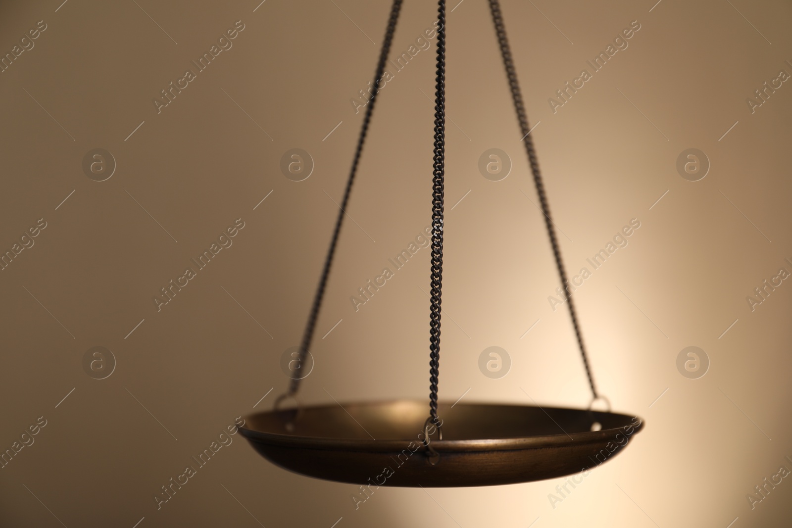 Photo of Scales of justice on beige background, closeup